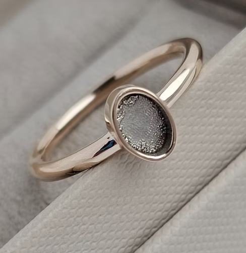 9ct rose gold plain oval ring angled view showing neat oval bezel sitting proud on fine plain band