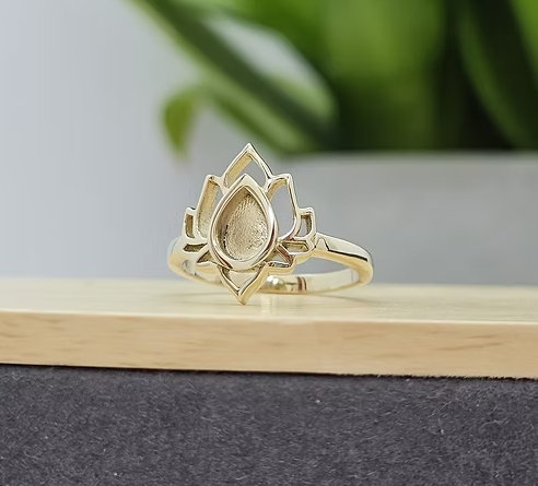 9ct yellow gold lotus flower ring blank, front view showing layered lotus petals and teardrop pear-shaped recessed centre bezel