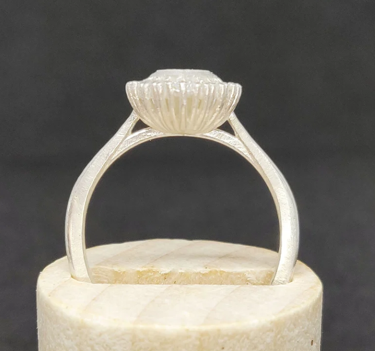 925 sterling silver marquise cut CZ halo memorial ring — side profile on wooden cone showing cathedral shank height and ribbed gallery detail