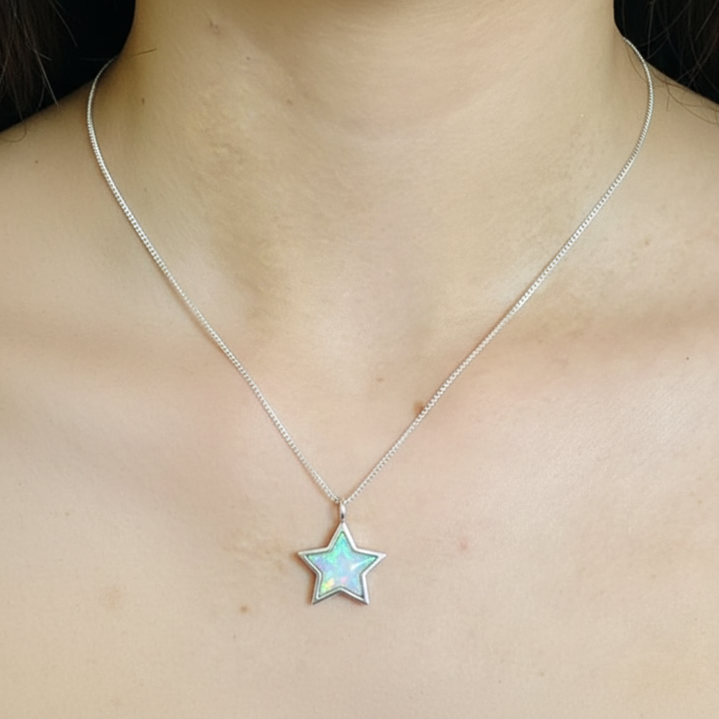 Silver 925 star memorial pendant worn on model — true 18x18mm scale lifestyle shot