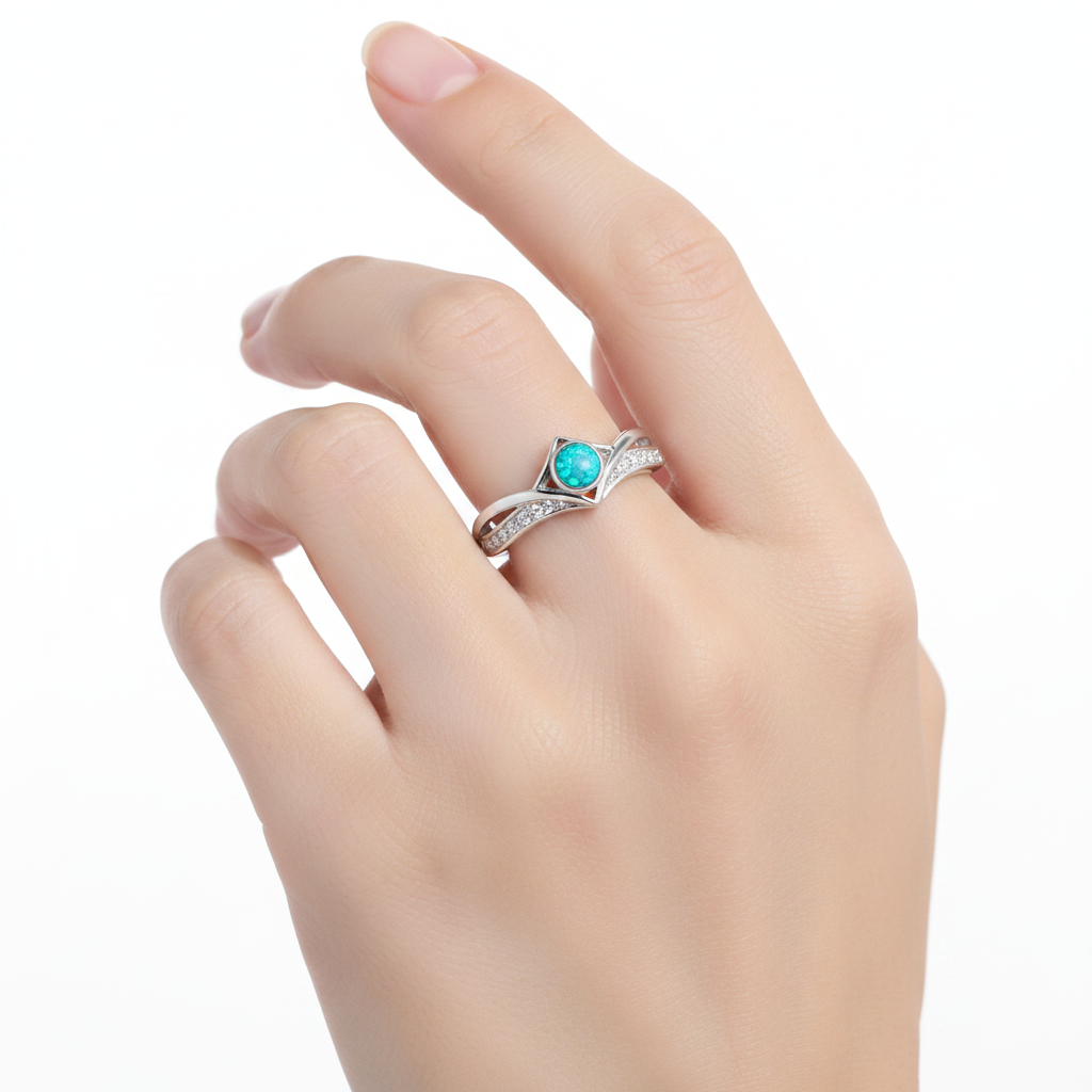 Silver 925 CZ inverted wishbone ring with blue teal opal resin worn on finger lifestyle shot white background
