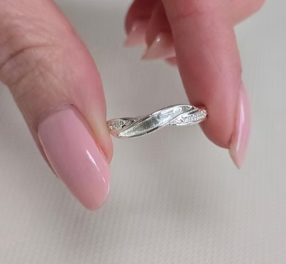925 sterling silver single recess band memorial ring held between fingers showing true scale and CZ detail