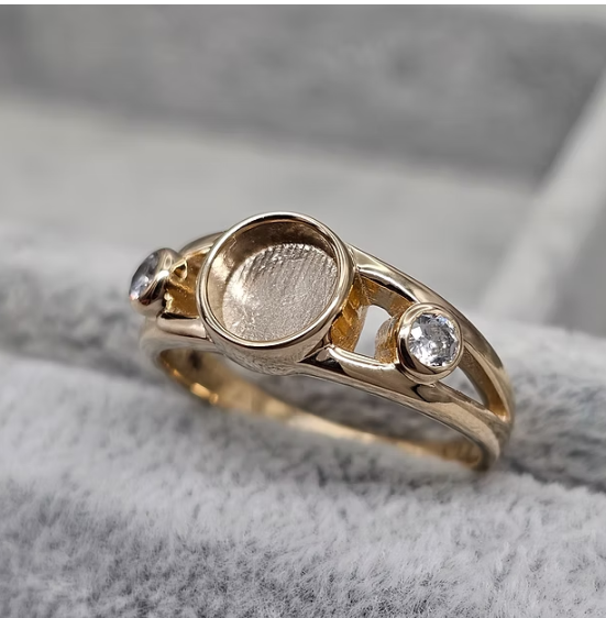 9ct yellow gold double split shank ring angled top view showing round centre bezel and duo CZ stones