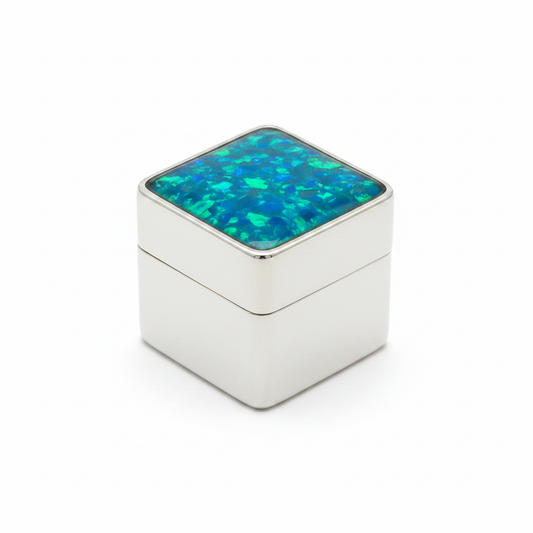 Silver 925 square pill box with blue teal opal resin in open bezel top on white background