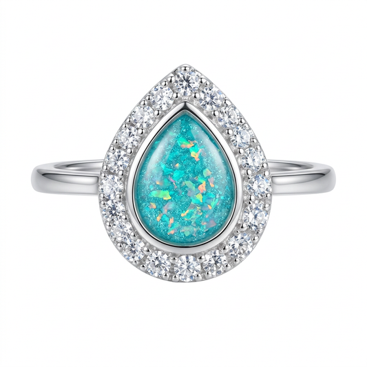 Revised illustrative pear CZ halo memorial ring with plain tapered shoulders and turquoise opal flakes