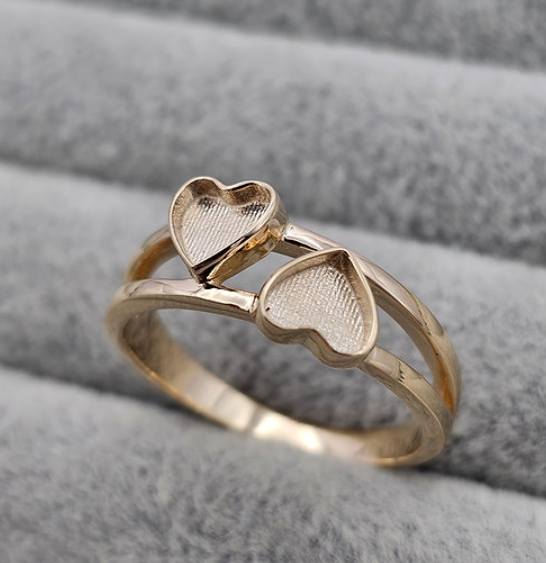 9ct gold double heart duo ring close-up on fingers showing staggered heart bezels and double band at true scale