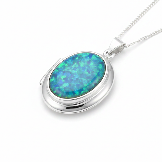Silver 925 oval hinged locket with blue teal opal resin in 18x13mm setting on white background