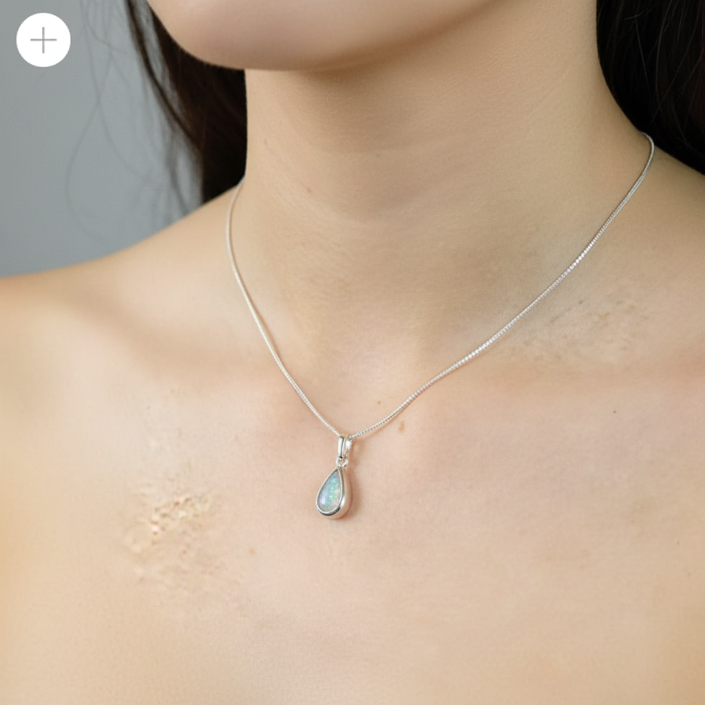 Silver 925 teardrop memorial pendant worn on model — true dainty scale lifestyle shot