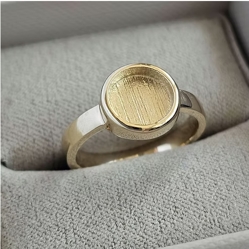 9ct yellow gold thick trim round bezel ring in jewellery box, front view showing large round recessed centre and thick polished gold trim