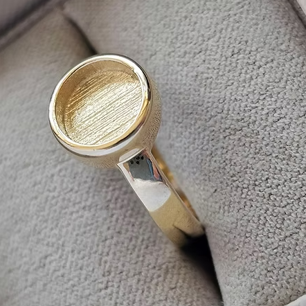 9ct yellow gold thick trim round bezel ring in jewellery box, angled top view showing the round bezel sitting proud on the polished band