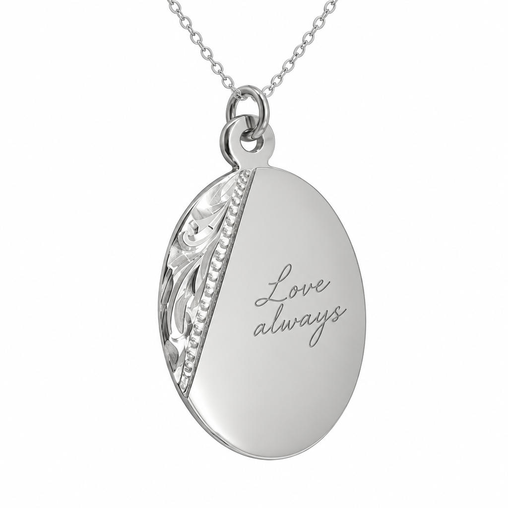 Illustrative handwriting engraving on decorative oval sterling silver pendant with included silver chain; original decorative side panel retained
