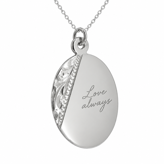 Illustrative handwriting engraving on decorative oval sterling silver pendant with included silver chain; original decorative side panel retained