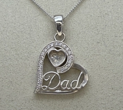 925 sterling silver Dad heart pendant close-up showing CZ pave stones along curved edge, Dad script lettering and small heart bezel at top