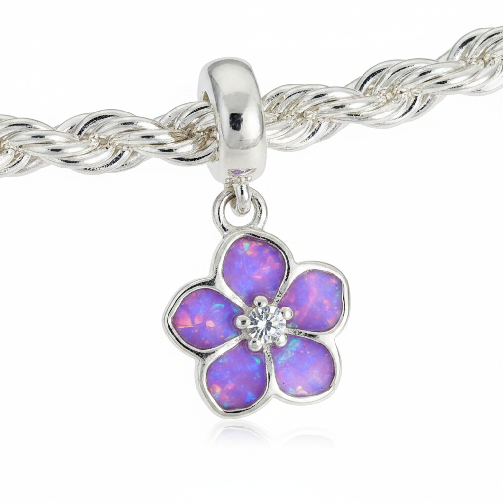 Close up macro of forget-me-not silver charm with lavender purple opal resin petals