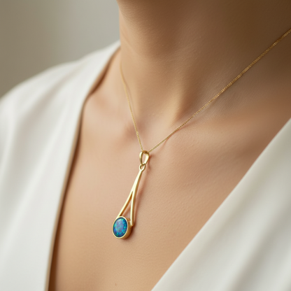 Model wearing 9ct gold elongated teardrop wire memorial pendant showing true scale on collarbone