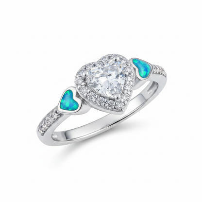 Silver 925 CZ heart cluster ring with blue teal opal resin in shoulder heart accents on white background