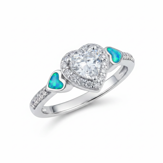 Silver 925 CZ heart cluster ring with blue teal opal resin in shoulder heart accents on white background