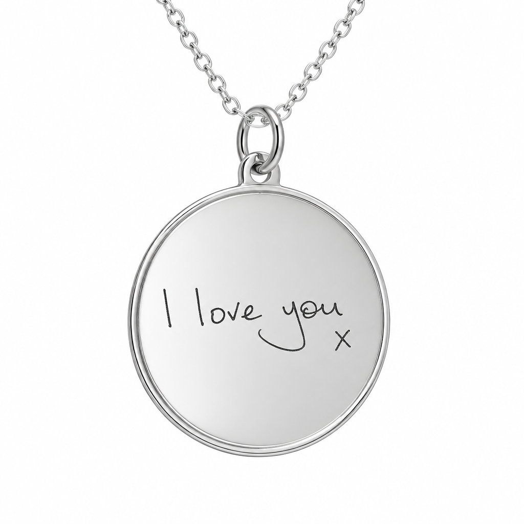Illustrative handwritten engraving on round lined border sterling silver pendant with chain, white background