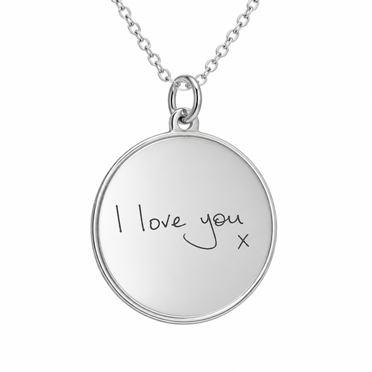 Illustrative handwritten engraving on round lined border sterling silver pendant with chain, white background