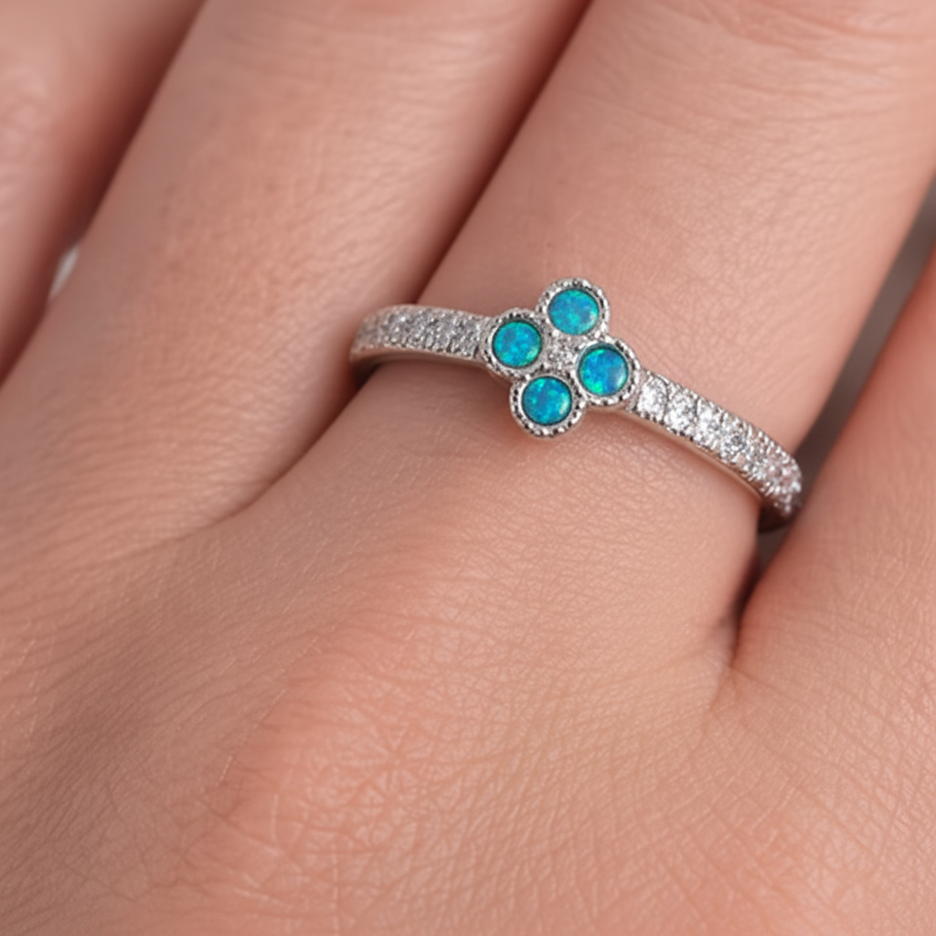 Petite clover 925 silver CZ ring with blue teal opal resin worn on finger white background