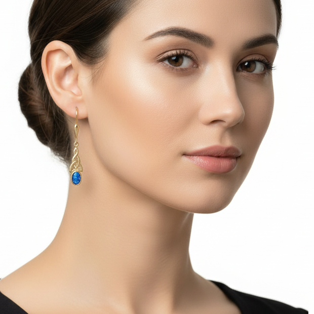 Model wearing 9ct gold Celtic trinity knot drop earrings showing true dainty scale on ear