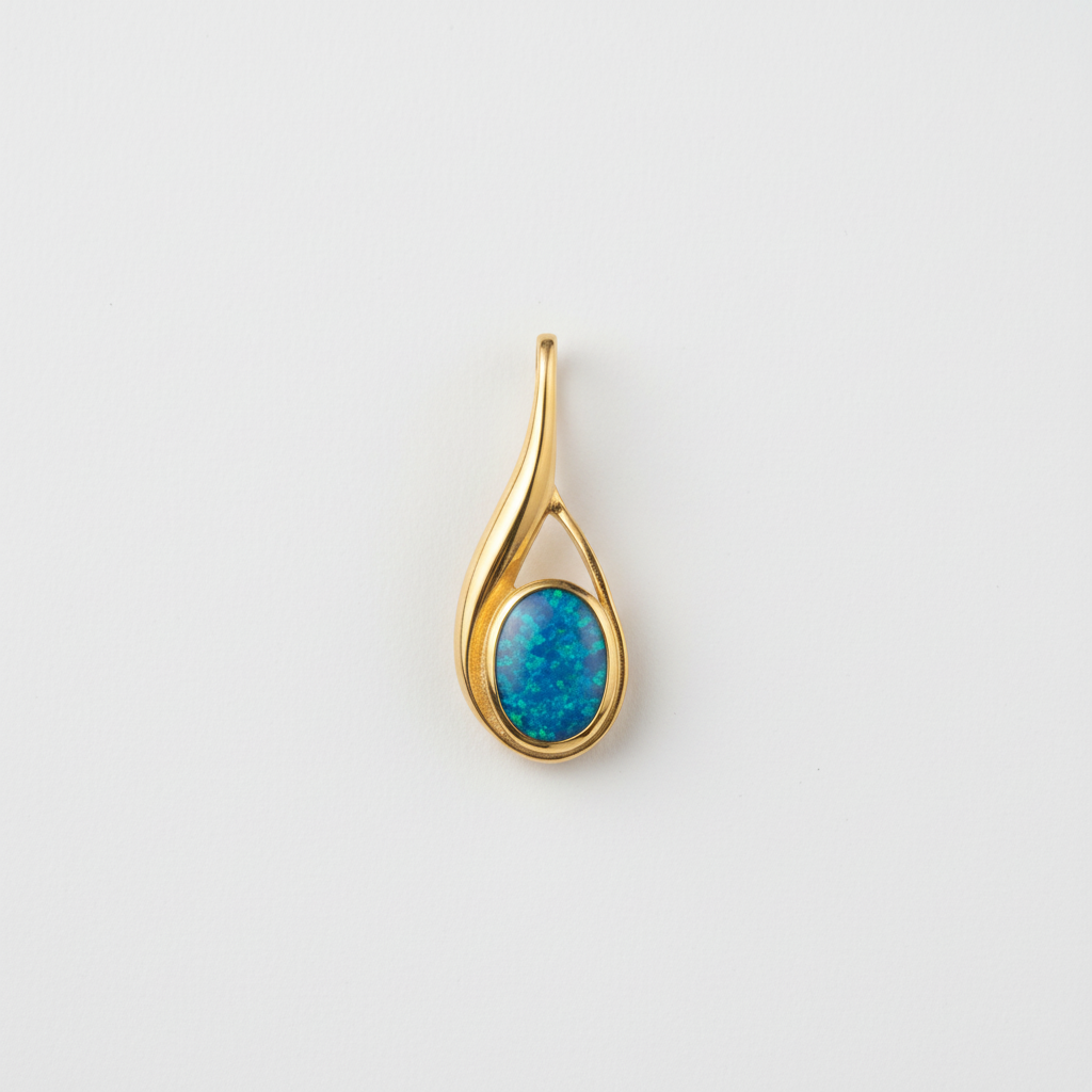 Hand holding 9ct gold teardrop swirl memorial pendant showing true scale – 29x11mm overall