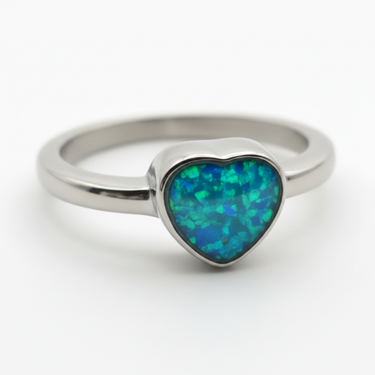 Stainless steel heart bezel memorial ring with blue teal opal flakes resin inclusion on white background