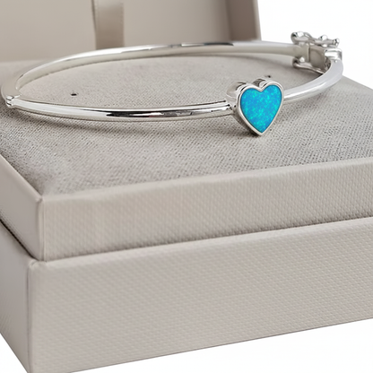 Bubble heart silver bangle with blue teal opal resin in heart bezel, white background