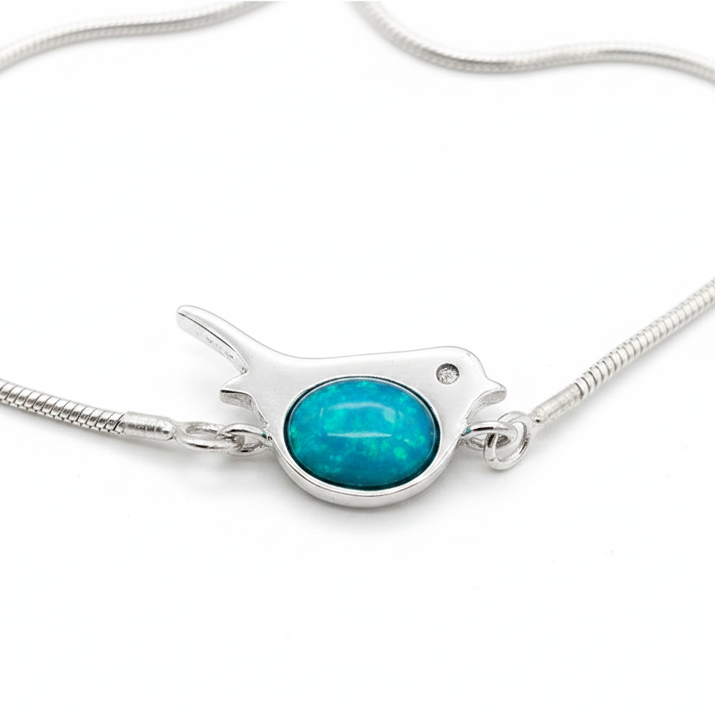 Robin silver snake chain bracelet close-up macro with blue teal opal resin in robin bezel, white background