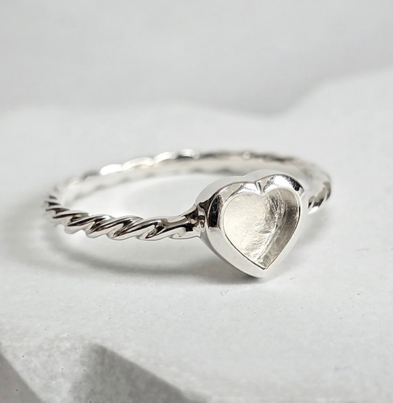 925 sterling silver twist heart memorial ring — side angle showing heart bezel and twisted band profile