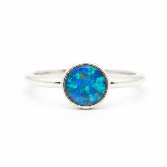 925 sterling silver 6mm cabochon rubover bezel memorial ring with blue teal opal flakes in flat resin setting on white background