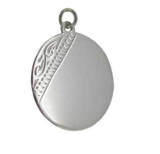 Original round silver pendant blank showing raised diagonal decorative section and smooth space for personalisation