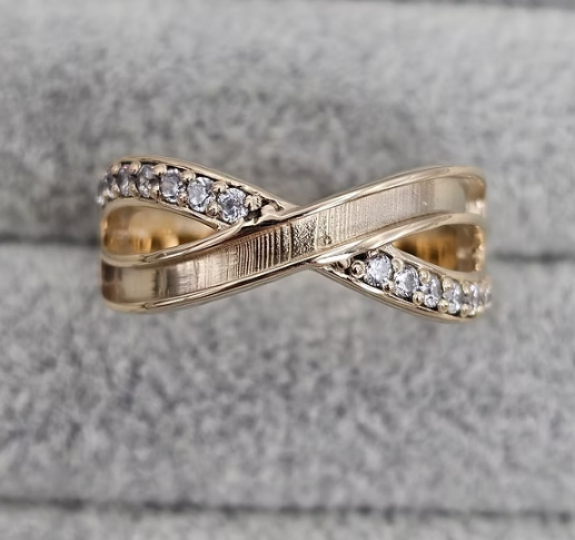 9ct yellow gold infinity CZ crossover ring top view showing CZ pavé arm and smooth arm