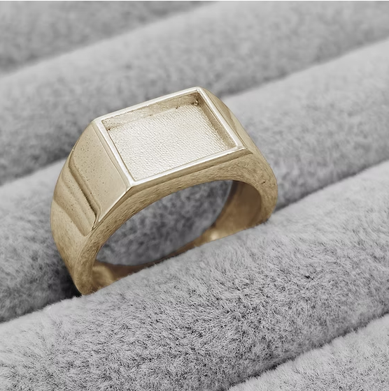 9ct yellow gold gents rectangular signet ring blank in jewellery box, angled view showing large flat rectangular bezel face and stepped sides