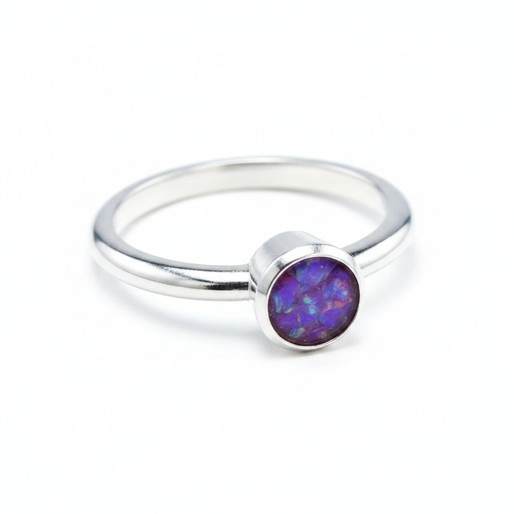 Handcrafted sterling silver rubover memorial ring with lavender purple opal flakes in flat resin setting on white background