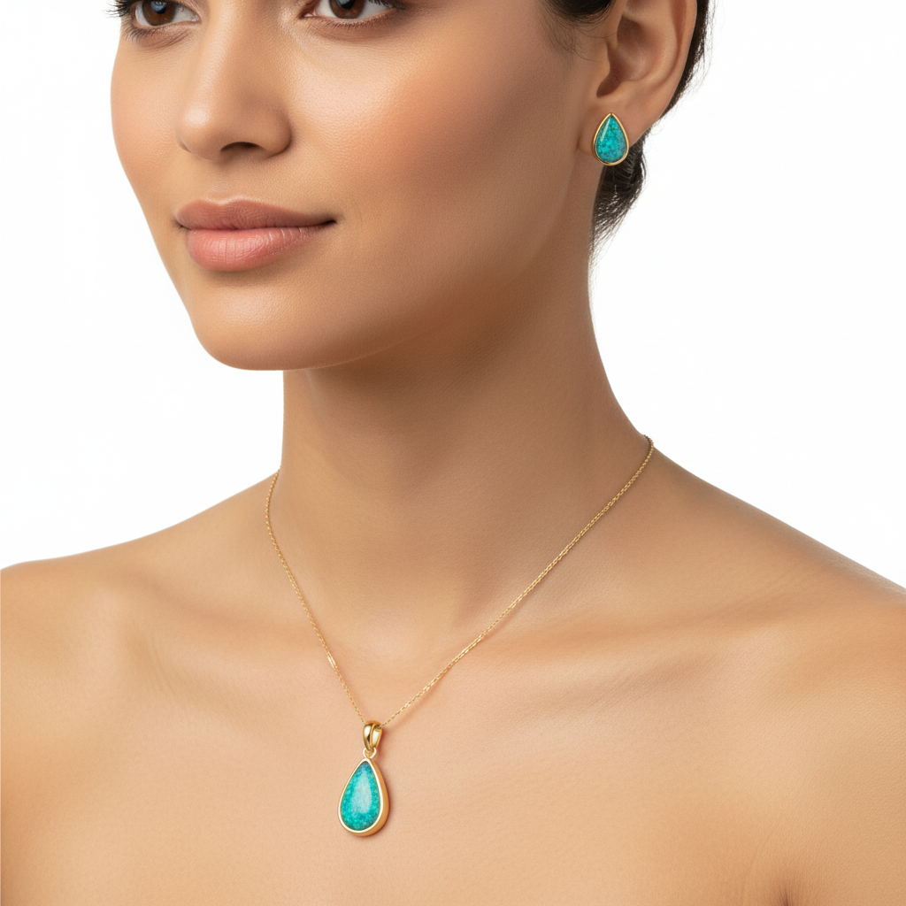 Model wearing gold teardrop pendant and pear stud earrings set