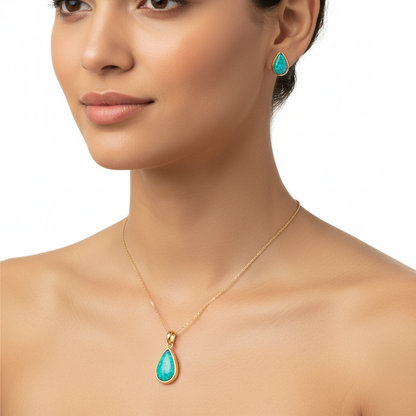 Model wearing gold teardrop pendant and pear stud earrings set