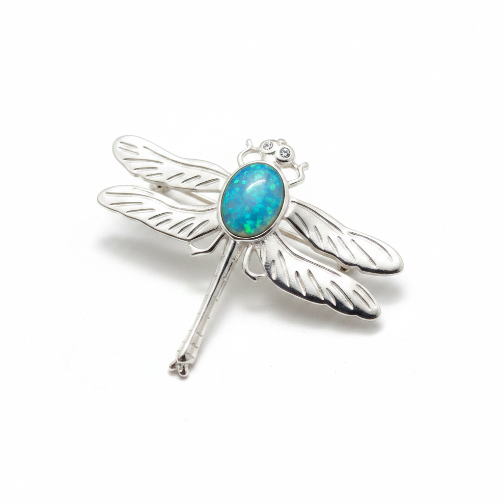 Silver 925 dragonfly brooch with blue teal opal resin in 10x8mm central setting on white background