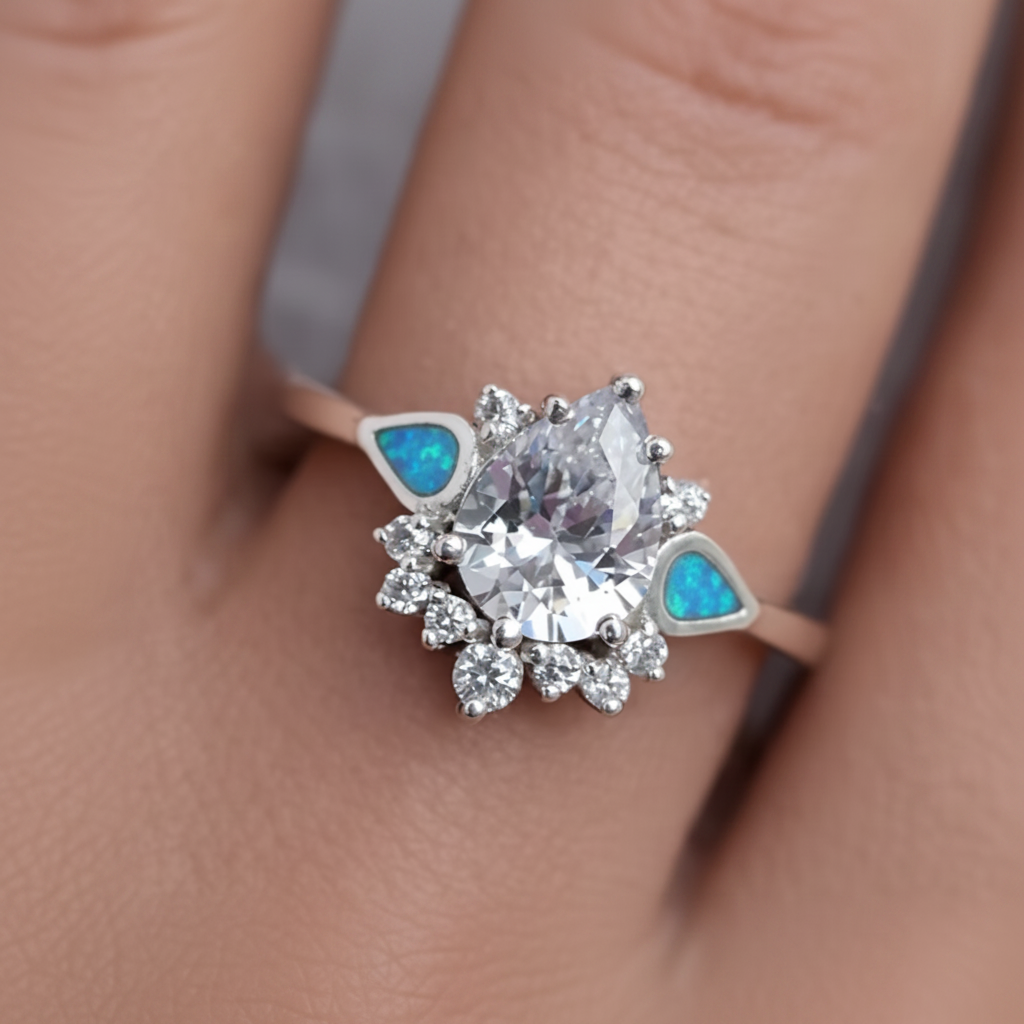 Silver 925 CZ dewdrop cluster ring with blue teal opal resin worn on finger lifestyle memorial jewellery shot