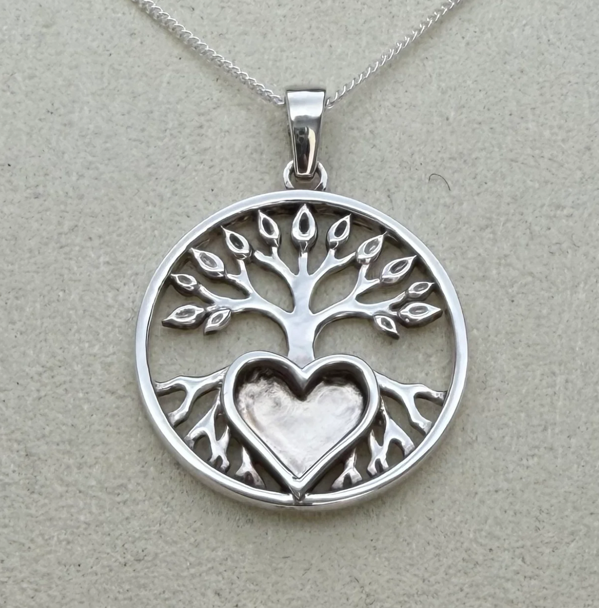 925 sterling silver tree of life pendant close-up showing intricate branch and leaf openwork detail and heart bezel set into roots