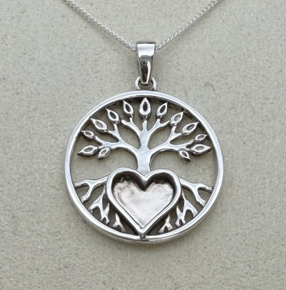 925 sterling silver tree of life pendant close-up showing intricate branch and leaf openwork detail and heart bezel set into roots