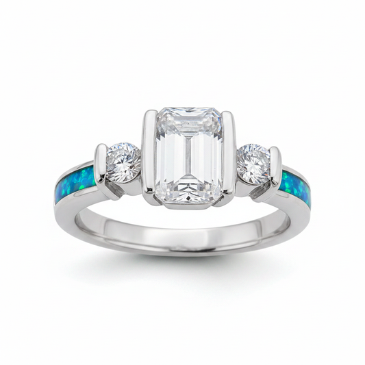 Emerald cut triple CZ bezel 925 silver ring with blue teal opal resin in side shank channels on white background