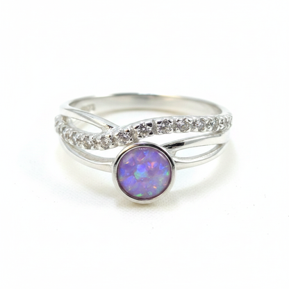 Silver 925 CZ crossover ring with lavender purple opal resin in 5mm central setting on white background