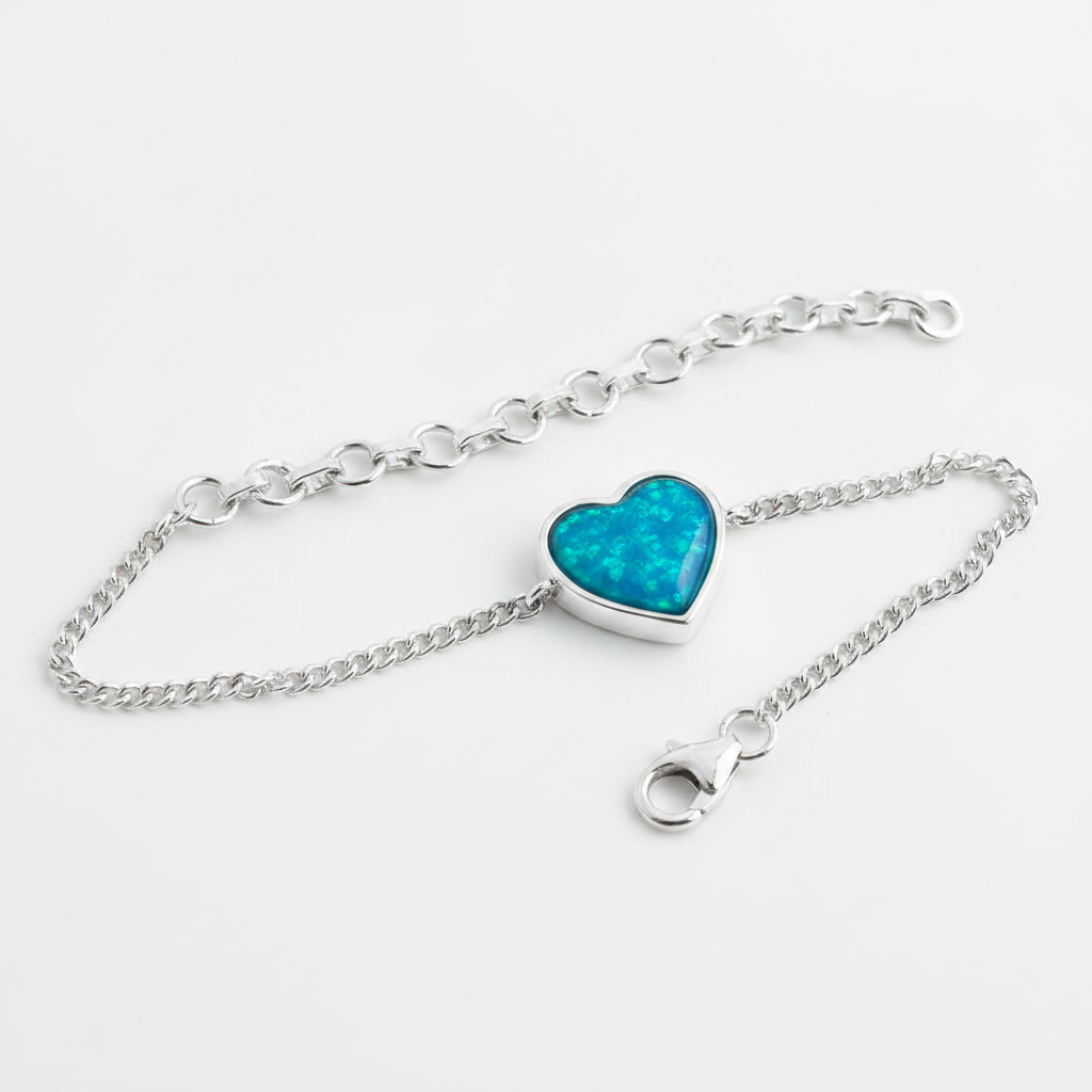 Heart curb chain silver bracelet with blue teal opal resin in heart bezel, white background