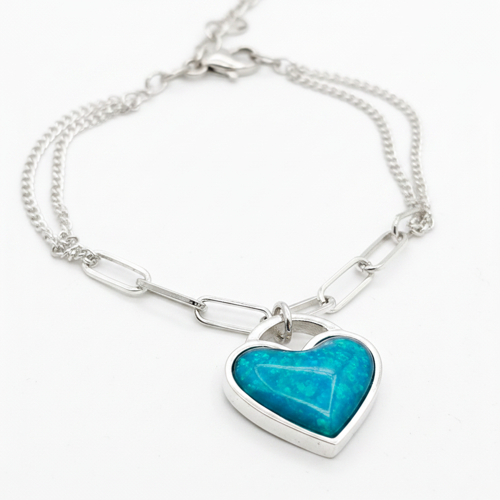Chunky heart paper clip silver bracelet close-up macro with blue teal opal resin in heart bezel, white background