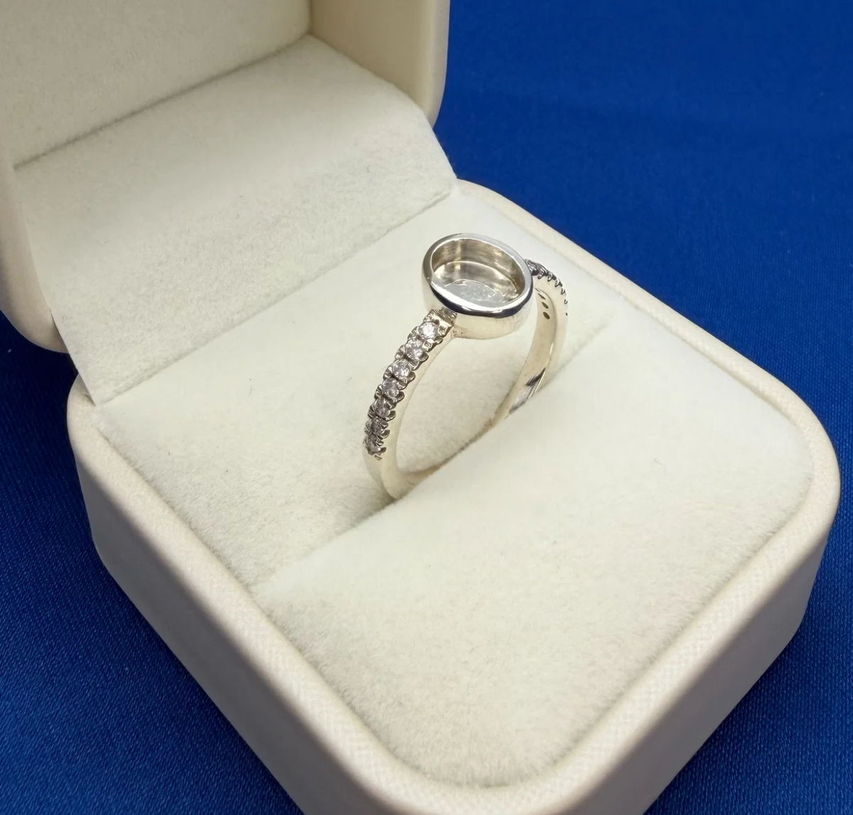 925 sterling silver oval multi CZ ring angled view showing oval bezel depth and CZ pave shoulder detail