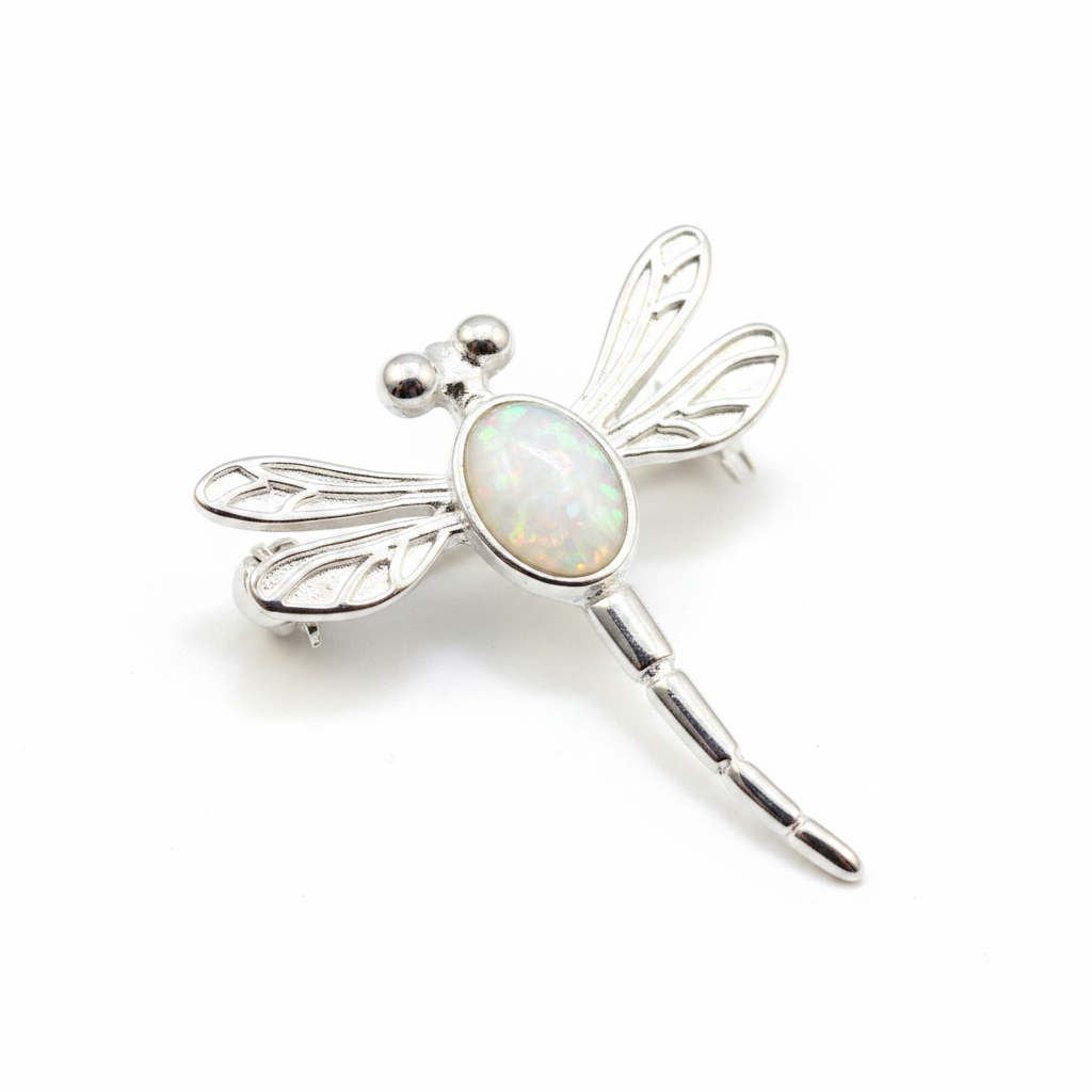 Silver 925 filigree dragonfly brooch with white pearl opal resin in 7x5mm central setting on white background