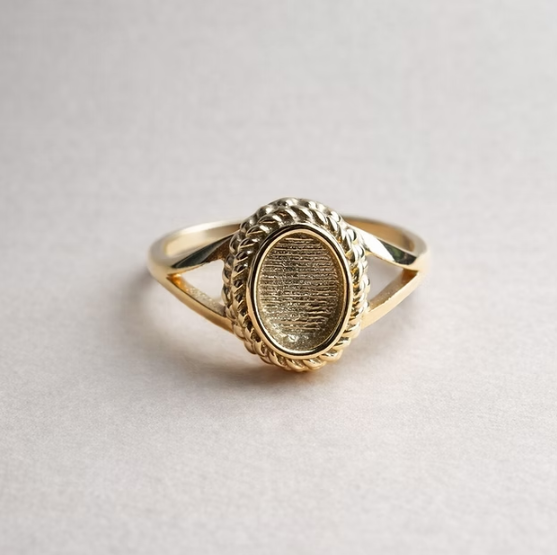 9ct yellow gold oval rope split shank ring angled view showing split shank band and oval bezel with twisted rope border