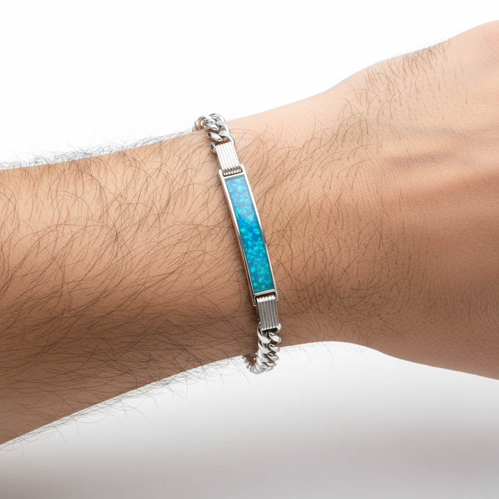 Gents silver curb chain ID bracelet with blue teal opal resin worn on man's wrist lifestyle shot