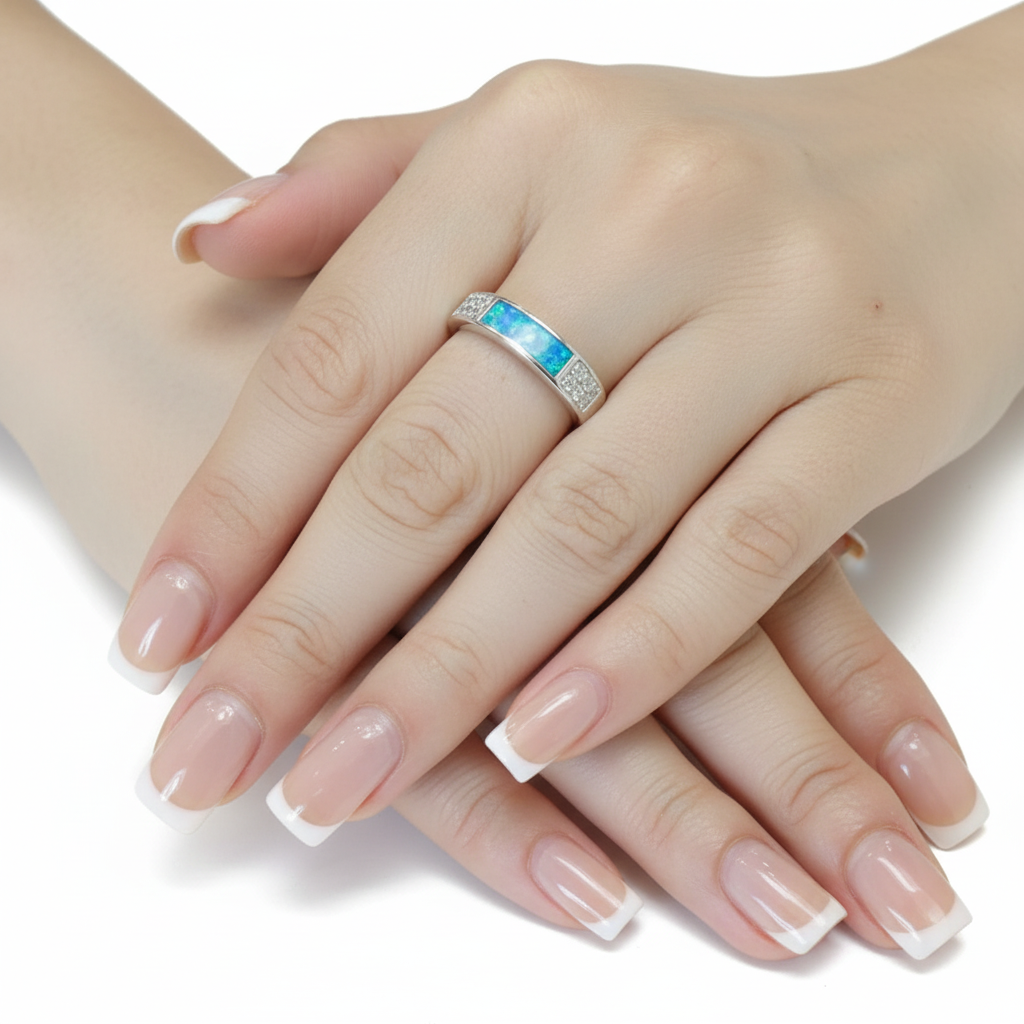 Silver 925 CZ band memorial ring worn on model finger — blue teal opal resin in rectangular channel, true scale lifestyle shot